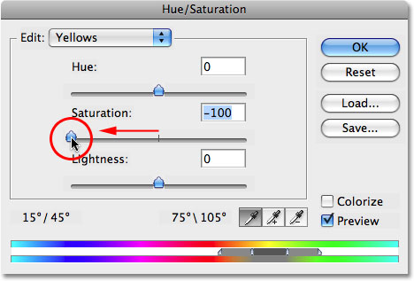 Dragging the Saturation slider to the left to remove the yellow from the teeth. Image © 2008 Photoshop Essentials.com.