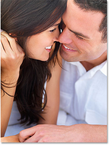 Close up of a smiling young couple in love. Image licensed from iStockPhoto by Photoshop Essentials.com