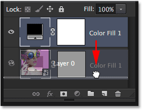 Dragging the Solid Color fill layer below Layer 0. Image © 2014 Photoshop Essentials.com.