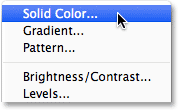 Choosing a Solid Color Fill layer from the Layers panel. Image © 2014 Photoshop Essentials.com
