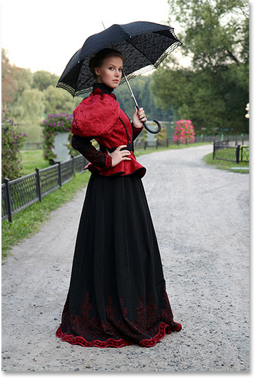 Girl with an umbrella in a vintage suit in a park. Image licensed from Shutterstock by Photoshop Essentials.com. Not to be used without permission.