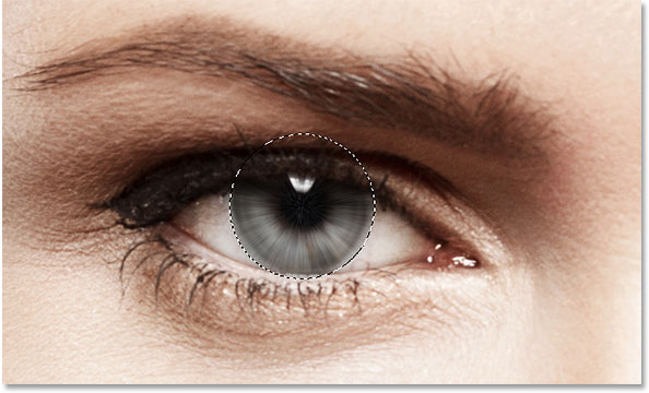 The image after applying the Radial Blur filter to the eye. Image © 2014 Photoshop Essentials.com.