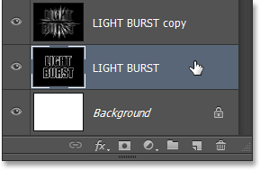 Selecting the original text layer in the Layers panel. Image © 2013 Photoshop Essentials.com