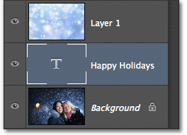 The Type layer has been moved below the image layer. Image © 2012 Photoshop Essentials.com