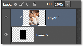 The Layers panel showing Layer 1 clipped to the layer below it. Image © 2012 Photoshop Essentials.com