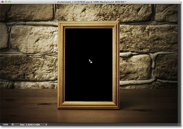 Selecting the area inside the photo frame with the Magic Wand Tool. Image &Copy; 2012 Photoshop Essentials.com