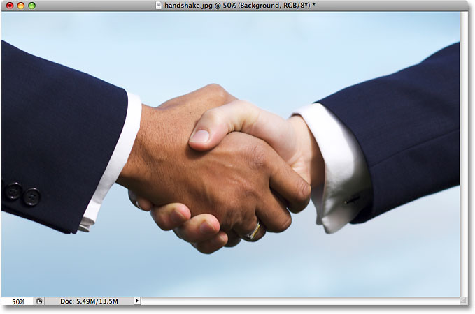 Two business people shaking hands. Image licensed by iStockphoto by Photoshop Essentials.com