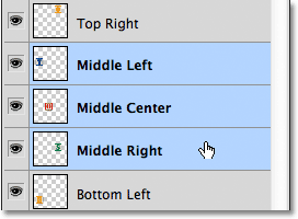 Selecting the Middle Left, Middle Center and Middle Right layers in the Layers panel. Image © 2011 Photoshop Essentials.com