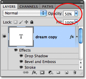 Lowering the Opacity of the text to 50%, with layer styles applied to the text. Image © 2011 Photoshop Essentials.com