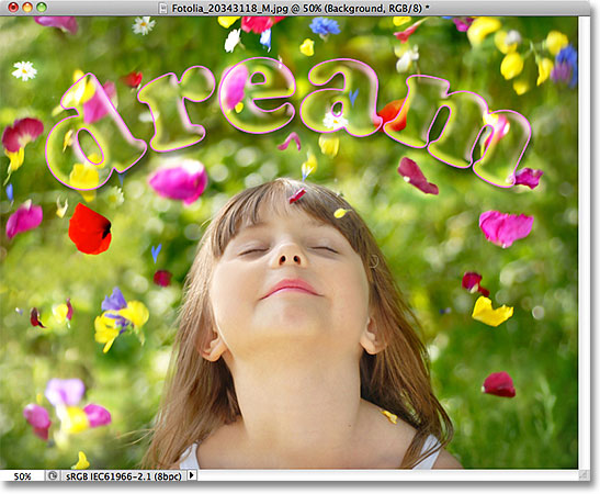 The text is now 100% transparent while the layer styles remain 100% visible. Image © 2011 Photoshop Essentials.com
