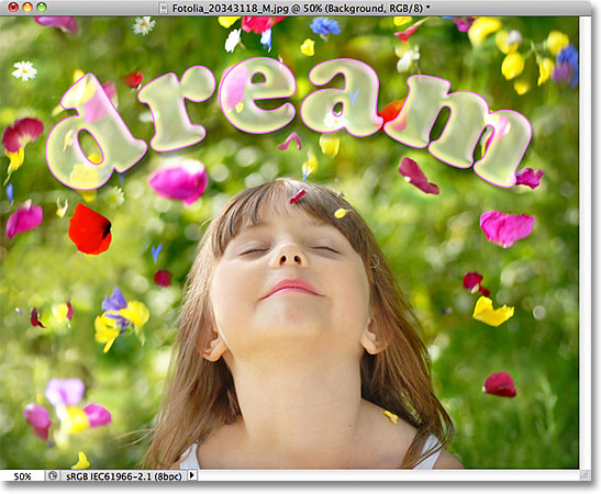 The text is now 50% transparent but the layer styles remain 100% opaque. Image © 2011 Photoshop Essentials.com