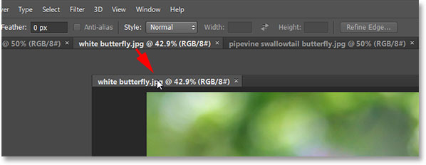 Dragging a tab to the right to change the order of the images. Image © 2013 Photoshop Essentials.com