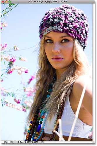 A colorful photo of a blond woman wearing a knitted cap. Image licensed from iStockphoto by Photoshop Essentials.com