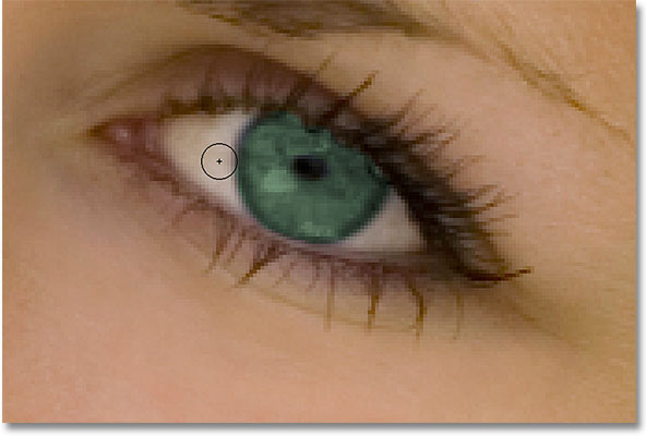Painting around the eye with black to hide the Hue/Saturation adjustment layer. Image © 2010 Photoshop Essentials.com
