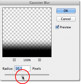 Dragging the Radius slider in the Gaussian Blur dialog box. Image © 2012 Photoshop Essentials.com.