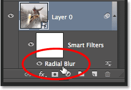 Double-clicking the Radial Blur Smart Filter in the Layers panel to re-open it. Image © 2013 Photoshop Essentials.com