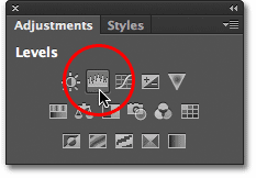 Clicking the Levels icon in the Adjustments panel. Image © 2012 Photoshop Essentials.com