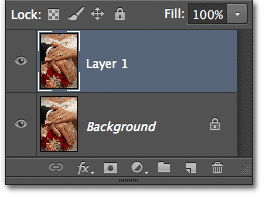 The Layers panel showing Layer 1 above the Background layer. Image © 2012 Photoshop Essentials.com
