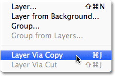 Selecting the New Layer via Copy command from the Layer menu. Image © 2012 Photoshop Essentials.com