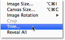 Selecting the Trim command from the Image menu. Image © 2014 Photoshop Essentials.com