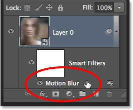The Motion Blur Smart Filter listed below the Smart Object in the Layers panel. Image © 2013 Photoshop Essentials.com