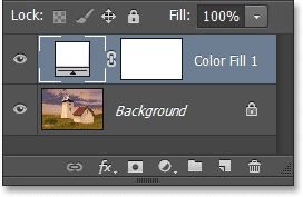 Selecting a Solid Color fill layer in the Layers panel. Image © 2013 Photoshop Essentials.com