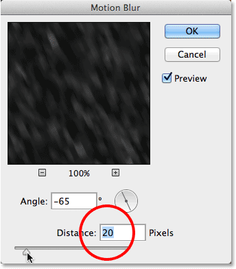 Increasing the Distance value in the Motion Blur dialog box. Image © 2013 Photoshop Essentials.com