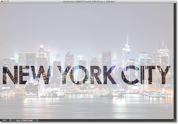 The photo on the Background layer is now visible through the shapes of the letters. Image © 2013 Photoshop Essentials.com.