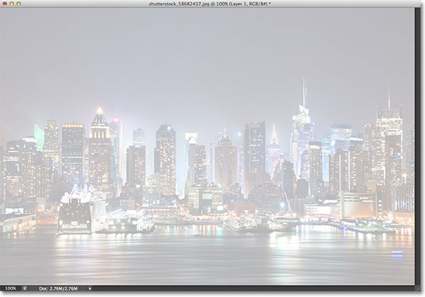 The photo is now visible through Layer 1. Image © 2013 Photoshop Essentials.com.