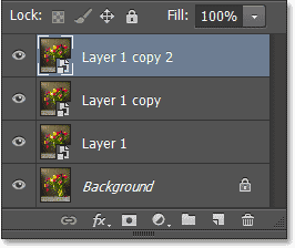The Layers panel showing the two copies of the Smart Object. Image © 2013 Photoshop Essentials.com